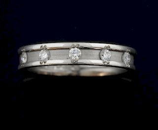 White gold and diamond wedding band ring, set with five round brilliant cut diamonds in a matt finish with polished edges. Mo