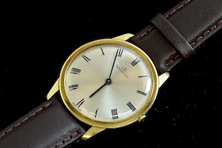 Gentleman's Jaeger lecoultre 18ct gold watch, silvered dial with Roman numeral hour markers. Fitted to an unsigned brown leat