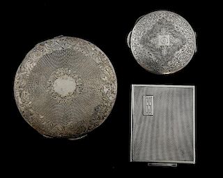 Three silver compacts, Large Continental compact with engraved decoration, similar smaller compact and an English compact Lon