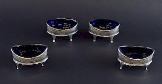 Two pairs of George III silver navette shaped table salts, one pair London 1795, makers Frances Purton, the other London 1791