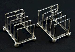 Pair of George V matched silver miniature four division toast racks on four ball feet, by William Hutton & Sons Ltd, Sheffiel