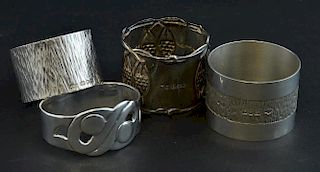Four silver napkin rings including one Birmingham 1927, makers Winifred King & Co., total weight 126g/4.05ozt,