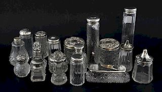 A quantity of silver topped cut glass  dressing jars (15) and three with plated tops