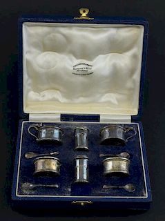 Modern silver six piece cruet set, comprising two salts and spoon, two mustard pots and spoons and two pepperettes, by Edward