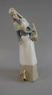 Lladro figure of a woman with a dog, signed,  27cm