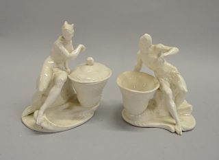 Pair of continental blanc de chine figural baskets in the form of an African male and female ( lacking one cover )