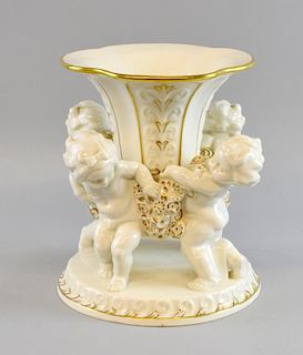 A German Hutschenreuther centrepiece designed circa 1925 by Karl Tutter, modelled as four putti lifting a central vase, with 