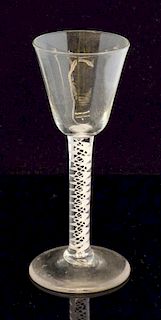 An 18th century cotton twist cordial glass with inverted bell bowl, pontil mark to foot 15cm high