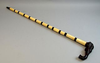 20th century bone and African hardwood walking stick with elephant's head handle, 88.5cm long,