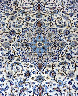 Persian type cream ground carpet with light blue borders, the centre with repeating foliate forms  340cm x 250cm