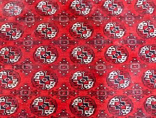 Afghan type red ground  carpet the centre with repeating medallions 370cm x 320cm