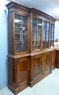 19th century mahogany break-front bookcase, top with four glazed doors base with four cupboard doors on plinth base.  240cm x