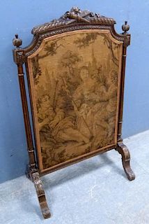 Victorian fire screen with tapestry panel, the cresting rair carved with a torch and quiver. 100 cm high, 60 cm wide