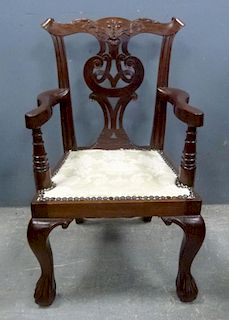 Chippendale style mahogany child's chair, curved arms, carved back and ball and claw feet,