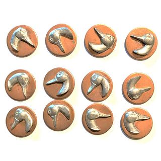 A SMALL CARD OF A SET OF COPPER AND SILVER BUTTONS