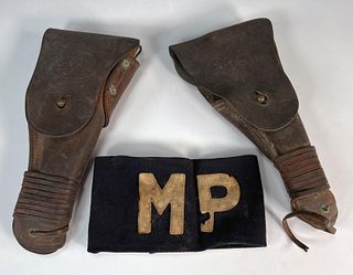 TWO U.S. MILITARY HOLSTERS AND MILITARY POLICE ARM BAND
