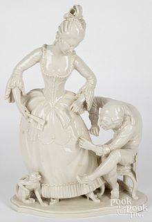 Glazed bisque figure of a woman and tailor