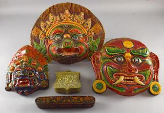 Three Asian painted wall masks of varying sizes, largest 12 inches, lacquer fan box & a brass carrying pouch.Provenance: From
