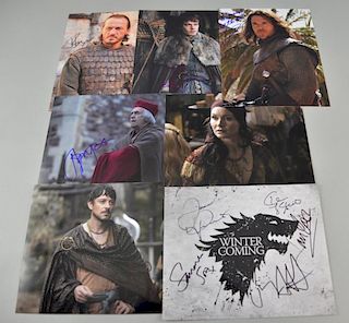 Games of Thrones: Seven autographed publicity stills, with twelve signatures, signatures including; Jerome Flynn, Alfie Allen