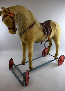 Toy horse on wheels and a non-matching carriage,