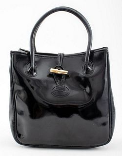 Longchamp black patent leather purse, with black leather interior lining with two pockets, made in France. 13.5" H x 9.5" W x 4.25" D,