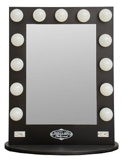 Vanity Girls Hollywood mirror with thirteen light bulbs, marked to bottom, on an ovular base. 35" H x 28" W x 13" D.