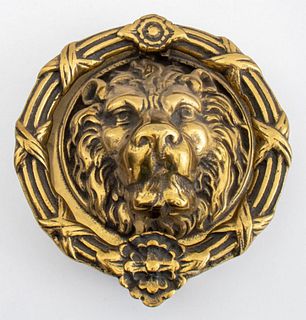 Neoclassical massive chased brass door knocker with lion figure to center. 2.75" H x 9.5" Diameter.