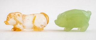 Chinese hardstone figures of pigs, one in green onyx or Bowenite, the other in quartz. 1.25" H x 3" L x 1.25" W (the larger).