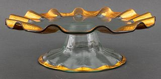 Gilded glass cake stand with scalloped edges. 4.5" H x 14.25" diameter.