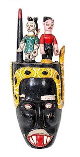 An African Carved Wood and Polychrome Decorated Ibibio Mask, Height 33 inches.