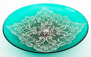Emerald green art glass footed charger with white enamel decoration in a lace motif, apparently unsigned. 2.5" H x 13.75" diameter. Provenance: Proper