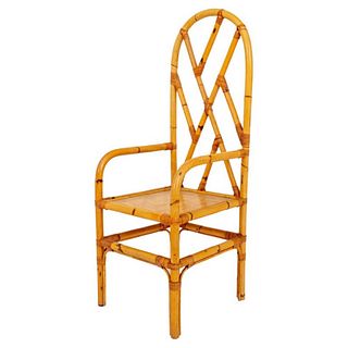 Chinoiserie style bamboo and rattan arm chair, with arched crest rail and trellis back, with down-scrolling arms and square woven seat. 50" H x 18" W 