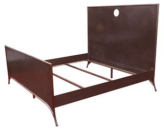 Industrial king size metal bed frame raised on tapered feet with openwork circular motif the headboard. 62.5" H x 83" W x 83" D.