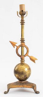 Classical ball and arrow table lamp, copper-toned brass, on a base with four claw feet, with an American plug. 19" H x 7.5" W x 6" D. Provenance: Prop