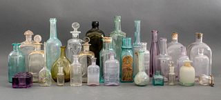 Group of thirty (30) vintage and antique bottles, various makers, origins and dates, one possibly an ancient lachrimarium. 10" H x 3" W x 3" D.