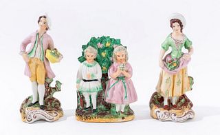 English Staffordshire group of three hand painted porcelain figures. Tallest: 7.75" H x 3.5" W x 2.5" D.