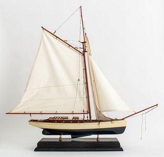 Wooden model of a schooner boat (rigging partially detatched). 34.5" H x 24" L x 6.5" D.