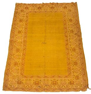 Vintage mustard yellow rug with a repeating floral pattern border. 7' 10" H x 4' 9" W.