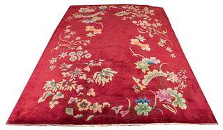 Chinese Art Deco carpet woven with a polychrome floral design on a red ground. 11' 3" H x 8' 10" W.