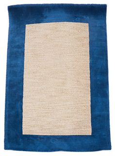 Wool rug with well defined blue border and taupe center, made in India. 8' H x 5' W.