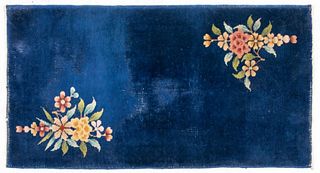 Small Chinese Art Deco style carpet with floral design on a blue ground. 3' 11" H x 2' 1/2" W.