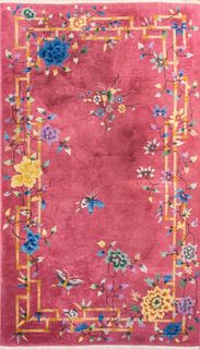 Chinese Art Deco style carpet with a floral geometric motif and butterflies upon a rose pink ground. 6' 10" H x 3' 11" W.