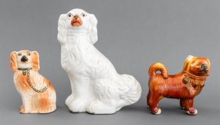 Group of three glazed ceramic dog figurines comprising (1) one stand Chinese dog and (2) two Staffordshire Beswick porcelain spaniel figures, unmarked