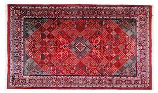 A Persian Wool Rug, 14 feet x 9 feet 10 inches.