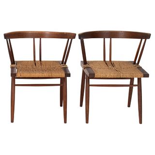 Pair of George Nakashima (American, 1905-1990) grass seated chairs, designed 1940s, of typical form in black walnut with rounded back above spindles o