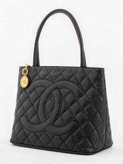 Chanel "Medallion" tote in caviar quilted black lambskin leather, the purse with two top handles embroidered with signature double C logo to fron