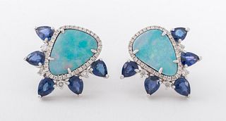 18K white gold, opal, and sapphire earrings, brightly polished, featuring two prong set pear shaped opal cabochons, weighing a total of approx. 6.49 c