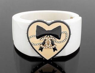 Chanel Runway white acrylic bangle bracelet with heart-form detail and bow design on a cream enamel ground and mounted with faux seed pearls, Spring 2