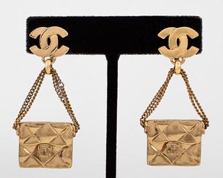 Pair of Chanel Runway gold-tone metal clip earrings with drop pendants in the form of quilted handbags suspended from signature double-C logos, Spring