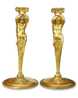 A pair of Classical-style figural brass candlesticks